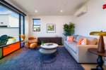Enjoy light pouring through avant-garde windows in living room and kitchen spaces
